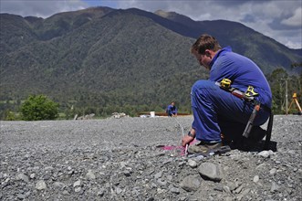 Builders mark out the profile for a building at a construction site in Westland, New Zealand,