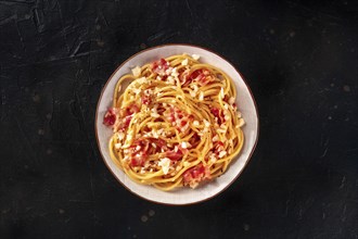 Carbonara pasta dish, traditional Italian spaghetti with pancetta and cheese, overhead flat lay