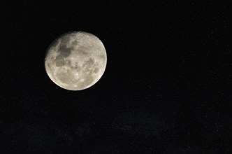 Beautiful photo of the full moon in close up with dark sky in the background