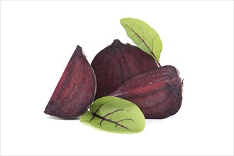 Slices of beetroot revealing their vibrant purple interiors complete with their fresh green leaves