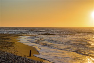 Den Helder, Netherlands. January 2022. Setting sun on the beach of Den Helder, Netherlands.