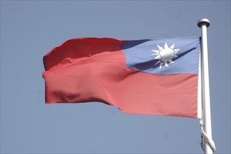 The flag of Taiwan against blue sky