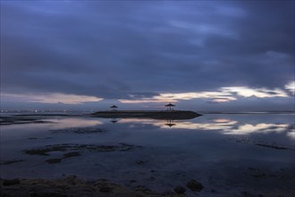 Beautiful seascape in the morning. Tropical sandy beach with breakwater and reflection of the sky
