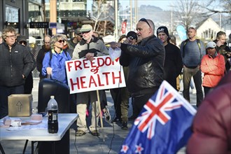 CHRISTCHURCH, NEW ZEALAND, JULY 24, 2021, A man speaks at a protest rally at the Bridge of