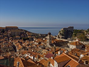 Panorama of a city with red tiled roofs and a castle by the sea, dubrovnik, Mediterranean Sea,