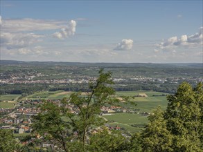 A wide view of a town and fields, surrounded by trees and clouds in the sky, Dürnstein, Wachau,