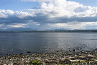 Scattered rain clouds on the east coast of Vancouver Island in Canada