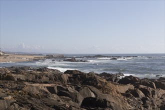 View of rocks and surf in the Atlantic Ocean at Praia do Molhe in Nevogilde, Norte region, Porto