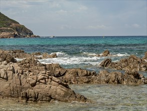 Rocky coastal landscape with waves and turquoise-coloured water, Corsica, Mediterranean Sea,