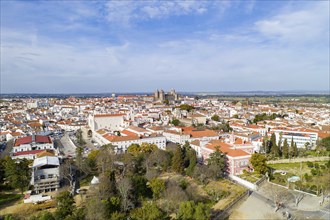 Evora drone aerial view on a sunny day with historic buildings city center and church in Alentejo,