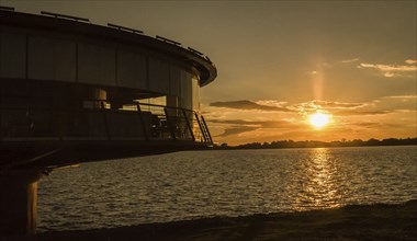 Panoramic restaurant on the Guaíba waterfront in silhouette at sunset