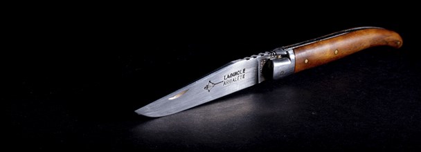 Amsterdam, netherlands. june 2022. Close up of a Laguiole folding knife on a black background.