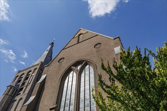 Impressive brick church with large windows and blue sky in the background, Borculo, netherlands