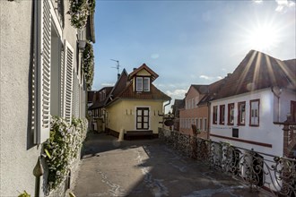 Old houses around a village square with bright sunshine