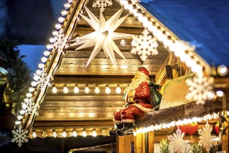 Christmas decorations with a seated Father Christmas and lots of electric light bulbs