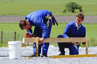 Builders mark out the profile for a building at a construction site in Westland, New Zealand,