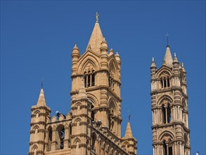 Close-up of the gothic towers of a cathedral under a blue sky, palermo, sicily, mediterranean sea,