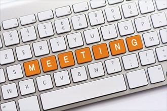 MEETING writing on white keyboard
