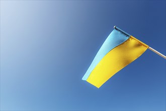 Large bicolor yellow blue Ukrainian state flag, national symbol fluttering, waving in wind against