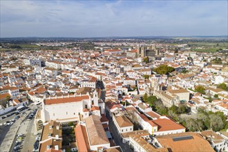 Evora drone aerial view on a sunny day with historic buildings city center and church in Alentejo,