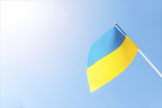 Large bicolor yellow blue Ukrainian state flag, national symbol fluttering, waving in wind against