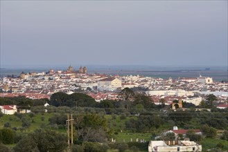 Evora city historic buildings and church view at sunset from a viewpoint on the outside in