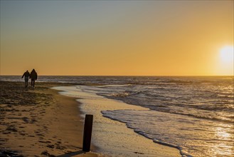 Den Helder, Netherlands. January 2022. Setting sun on the beach of Den Helder, Netherlands.