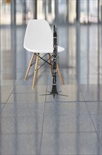 Clarinet and a white chair in an auditorium