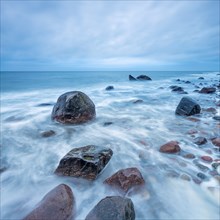 Stormy Baltic Sea in winter, boulders in the surf, near Rerik, Mecklenburg-Western Pomerania,