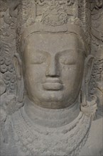 Figure of Shiva in the main cave of the Shiva temple on Elephanta Island, UNESCO World Heritage