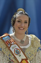 Fallas festival, woman in a traditional costume during the parade in the Plaza de la Virgen de los