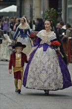 Fallas festival, parade, flower offering, at Plaza de la Virgen de los Desamparados, Valencia,