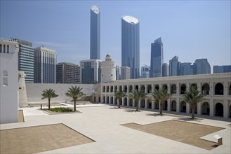 Old fort and museum Qasr al Hosn in front of skyscrapers, oldest building in Abu Dhabi City,