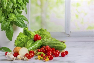 Fresh vegetables, salad ingredients, cucumber, tomatoes, lettuce, basil, pepperoni, onion cut,