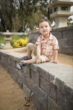 Young chinese and caucasian boy having fun at the park