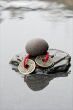 Stones and Chinese lucky coins, coins, lucky coins, lucky coin, coin, in water