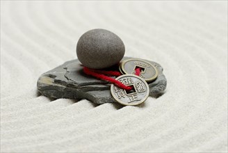 Stones and Chinese lucky coins, coins, lucky coins, lucky coin, coin, in sand