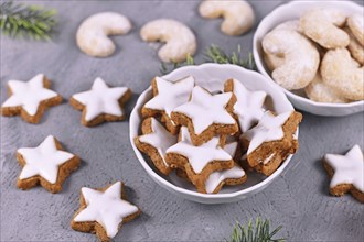 Bowl with traditional German cinnamon star Christmas cookies called 'Zimtsterne' made with almonds,