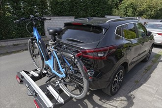 Car with e-bike on rear bike rack, parked on the road, Düsseldorf, North Rhine-Westphalia, Germany,