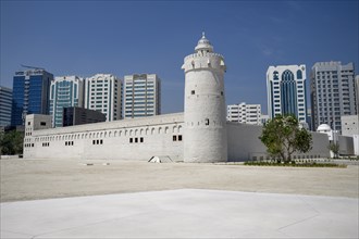 Old fort and museum Qasr al Hosn in front of skyscrapers, oldest building in Abu Dhabi City,