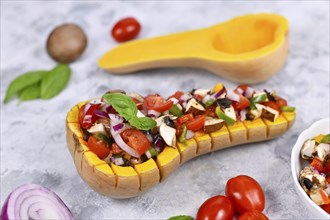 Vegan baked Butternut squash vegetable filled with bell pepper, cherry tomatoes, red onion and