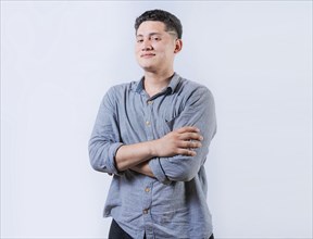 Portrait of smiling latin man with arms crossed isolated. Young casual latin man smiling at camera.