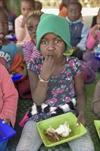 Child eats rice from plastic plate, Preschool for orphans, Katutura district, Windhoek, Khomas