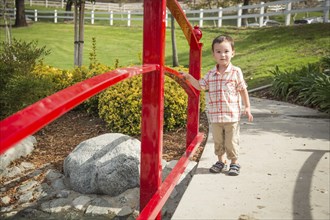 Young chinese and caucasian boy having fun at the park