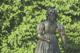 Sculpture and figure as a woman with Biedermeier clothing at the Datterich fountain at Luisenplatz,