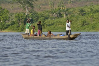 Fisher family on a pirogue on the Congo River, near Tshumbiri, Bandundu Province, Congo, Africa