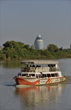 Sightseeing boat on the Nile, behind the futuristic Corinthia Hotel, Kharthoum, Sudan, Africa