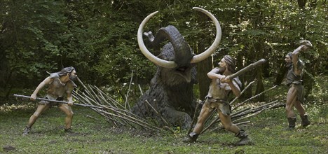 Diorama showing Neanderthal hunters killing trapped prehistoric mammoth at Prehisto Parc, theme