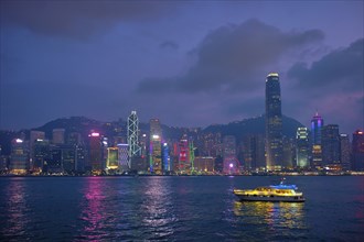 Hong Kong skyline cityscape downtown skyscrapers over Victoria Harbour in the evening illuminated