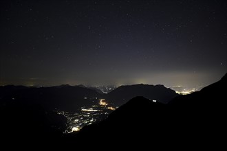 Night view of Berchtesgaden (centre) and Salzburg (right) with the Untersberg in between, seen from